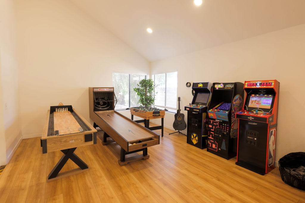The Home B game room, with shuffleboard, a bowling table and three arcade cabinets