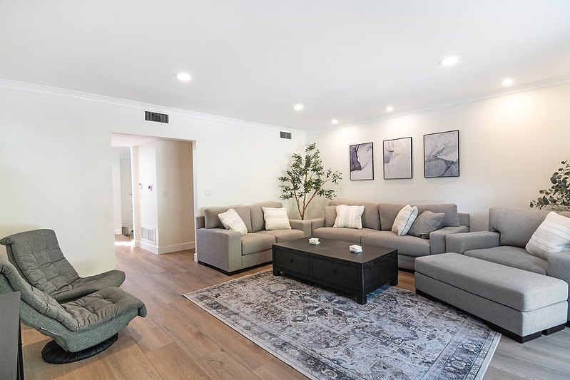 The living room at the Winnetka home, with gray sofas, a dark coffee table and an area rug